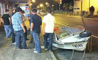 Stranded: Bystanders rescued this boat from the middle of the Pacific Highway on Sunday night. Stranded: Bystanders rescued this boat from the middle of the Pacific Highway on Sunday night.